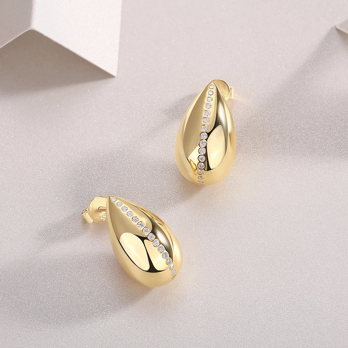 Gold-Plated Teardrop Moissanite Accent Stud Earrings — Angled pair