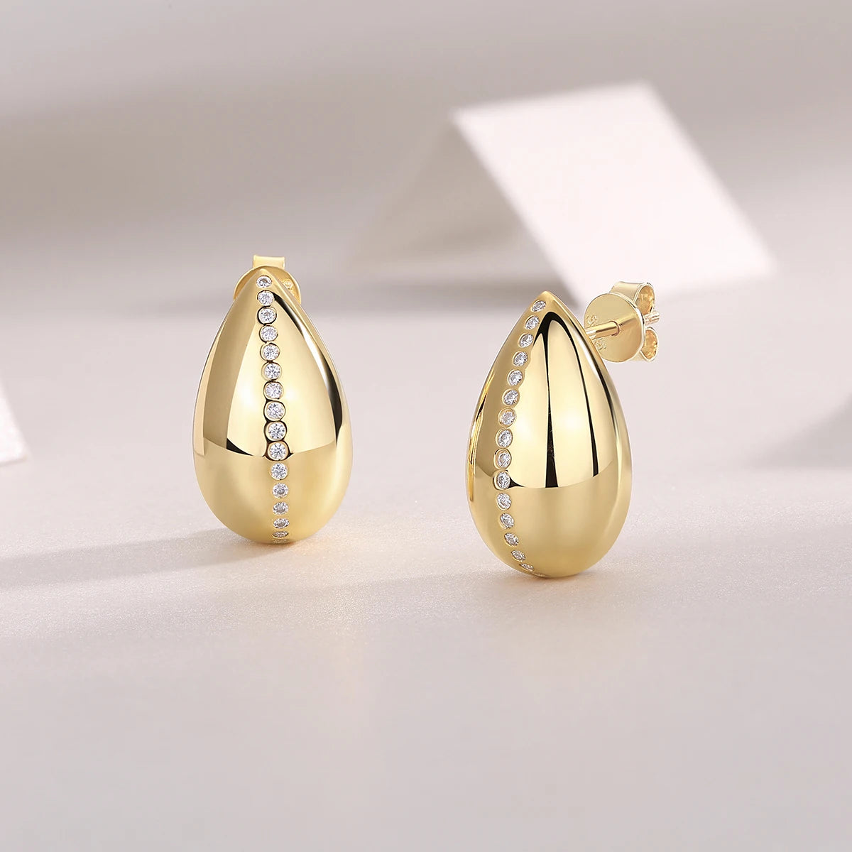 Gold-Plated Teardrop Moissanite Accent Stud Earrings — Polished teardrops and backs