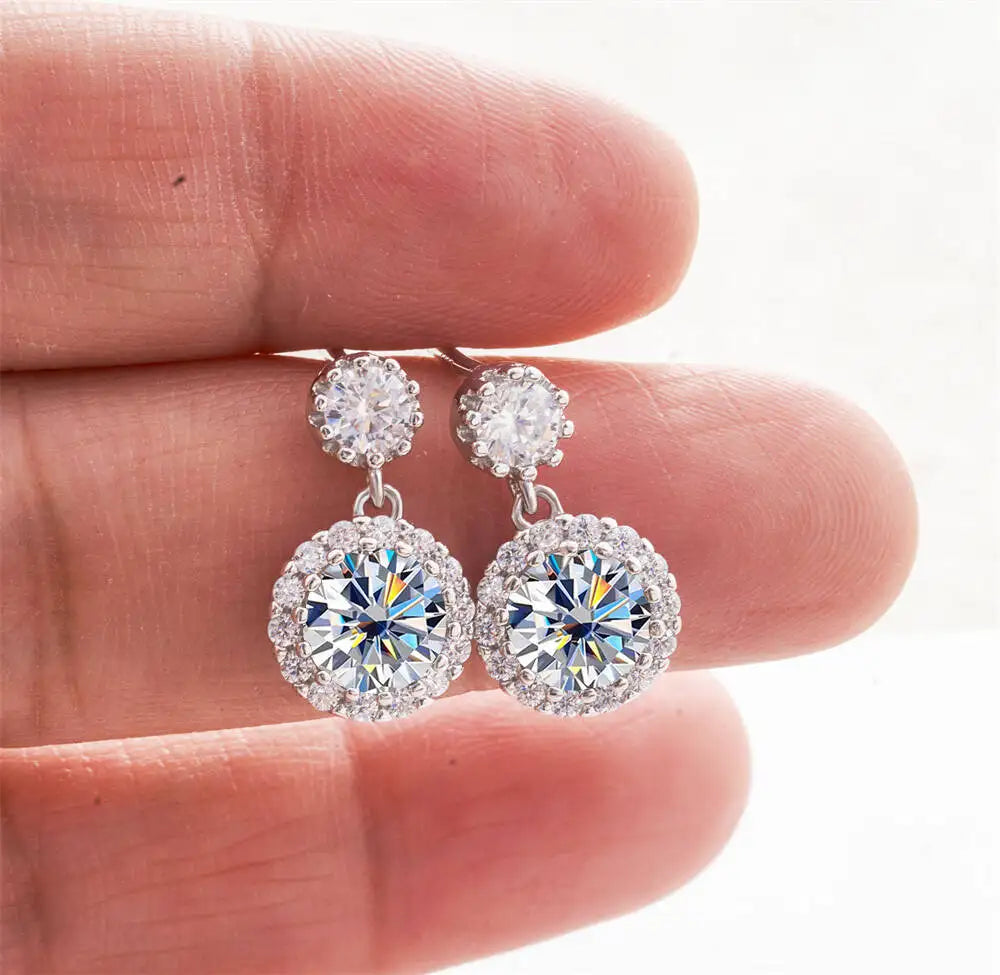 Moissanite Halo Drop Earrings in 925 Sterling Silver — White halo drops held in hand — BandsCo Straps