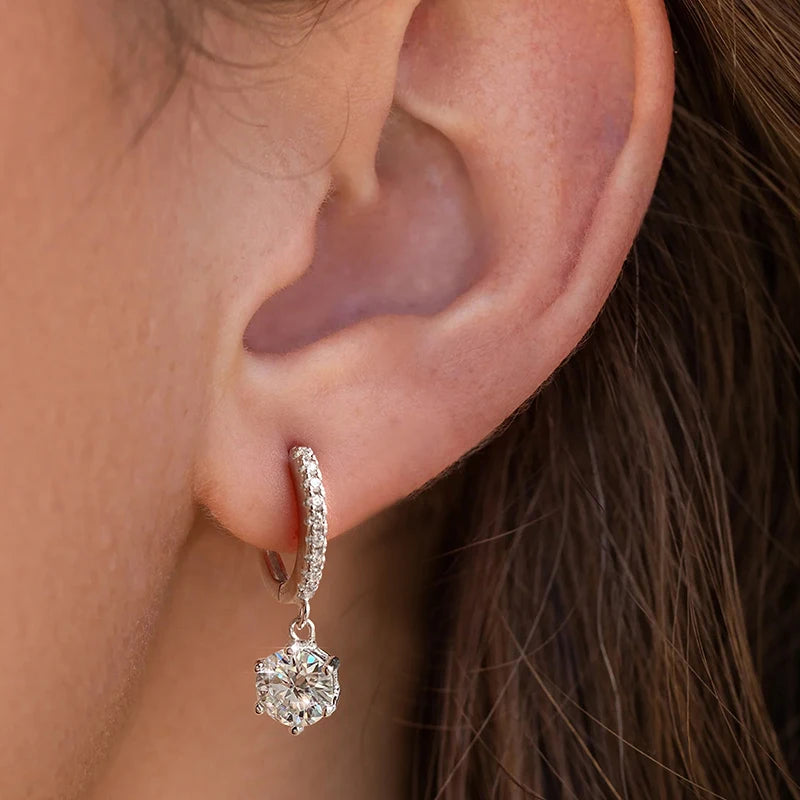 Round Moissanite Drop Huggie Earrings in 925 Sterling Silver — Shown on ear
