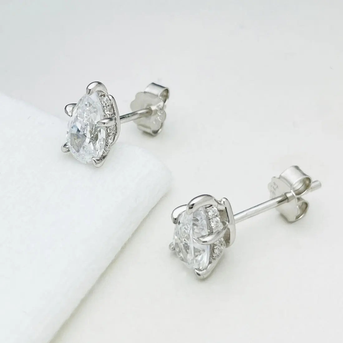 Pear Moissanite Stud Earrings in Sterling Silver — Stud pair on display