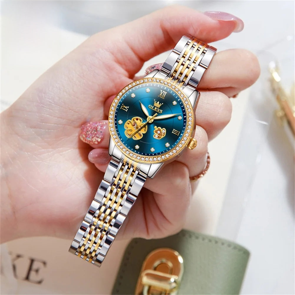 Women's Floral Openwork Automatic Bracelet Watch — Blue floral watch held in hand — BandsCo Straps