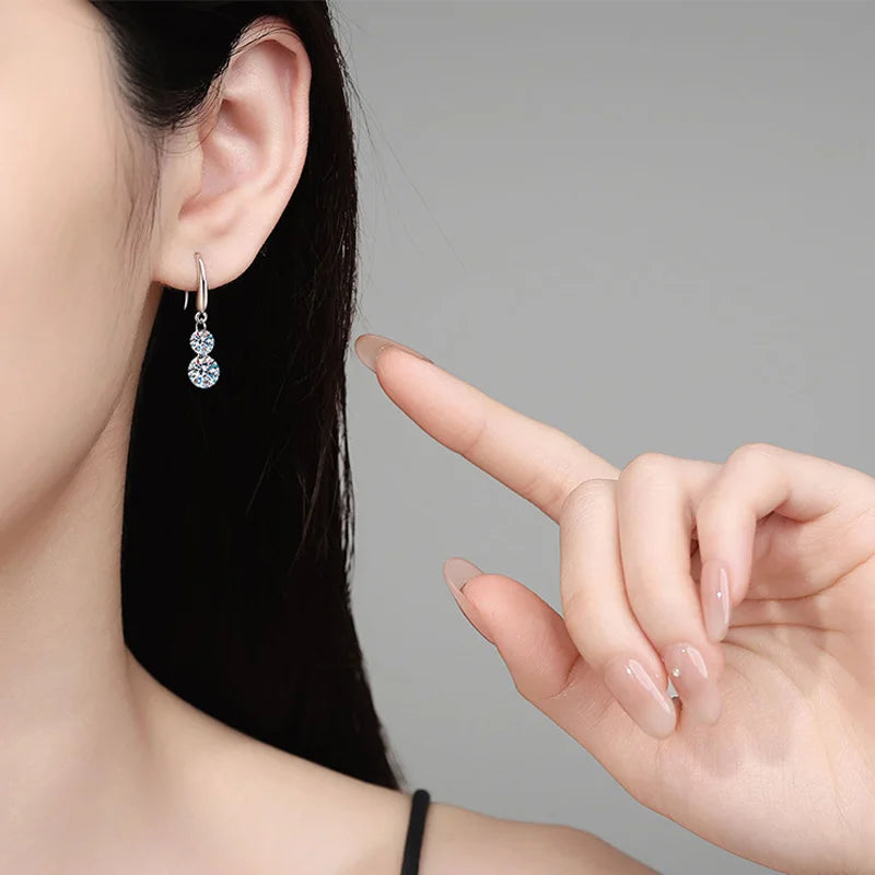 Two-Stone Moissanite Hook Drop Earrings in Sterling Silver — Shown on ear