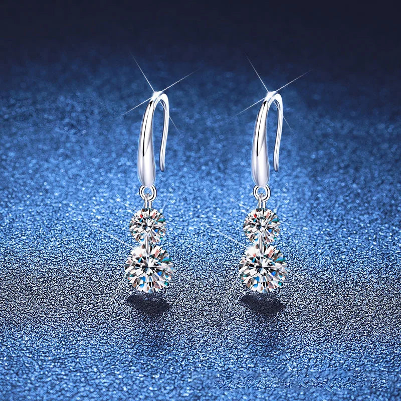 Two-Stone Moissanite Hook Drop Earrings in Sterling Silver — Pair on blue fabric