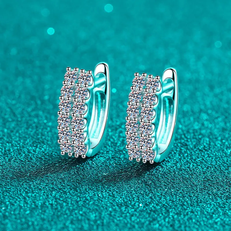 Pavé Moissanite Huggie Hoop Earrings in Sterling Silver — Pair on turquoise surface