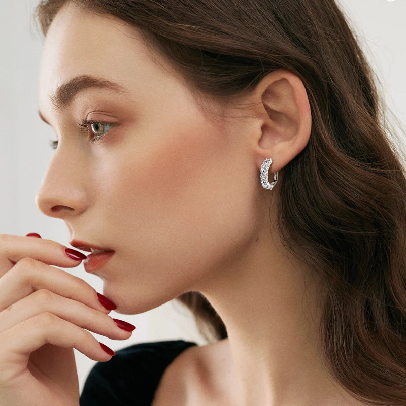 Moissanite Graduated Stone Hoop Earrings in Sterling Silver — Shown on ear