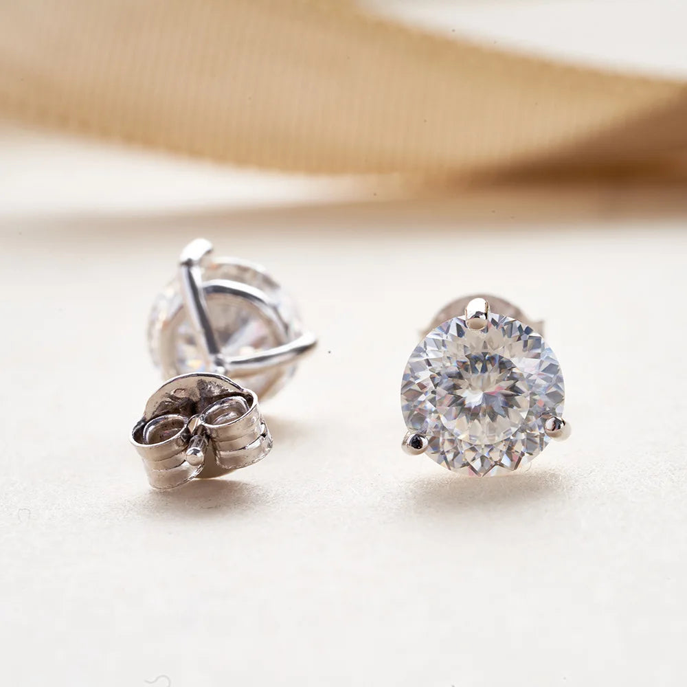 Colored Three-Prong Moissanite Stud Earrings in Sterling Silver — White faceted stones