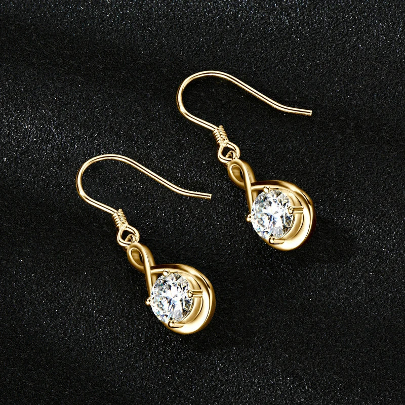Twisted Teardrop Moissanite Hook Earrings in Silver — Gold-tone pair on dark surface