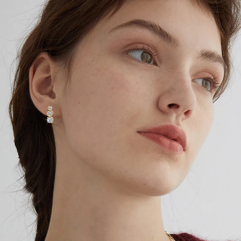 Three-Stone Twist Moissanite Stud Earrings in Sterling Silver - Three-stone earrings on model