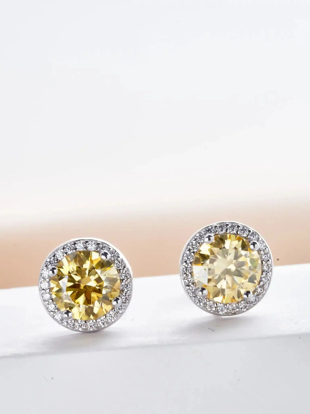 Colored Round Halo Moissanite Stud Earrings - yellow tones close-up