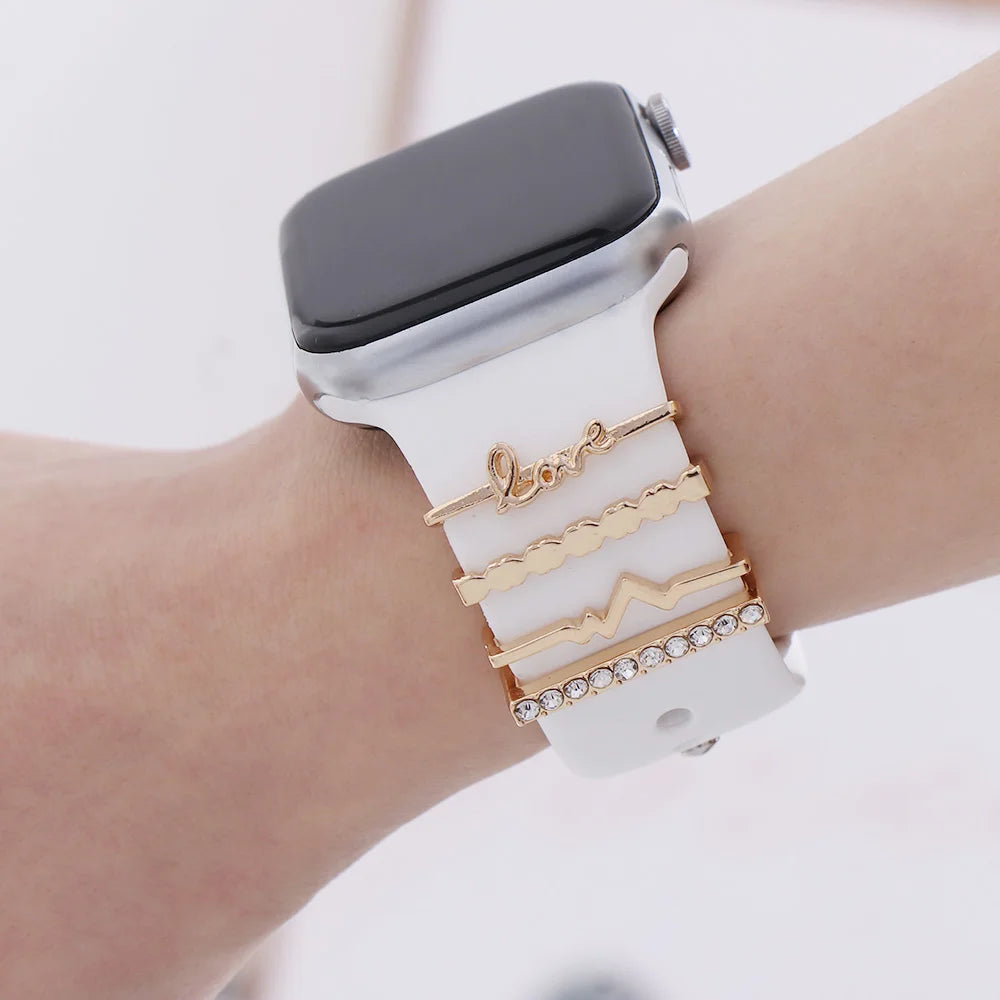 Decorative metal charms on an Apple Watch band featuring elegant designs for a stylish look.