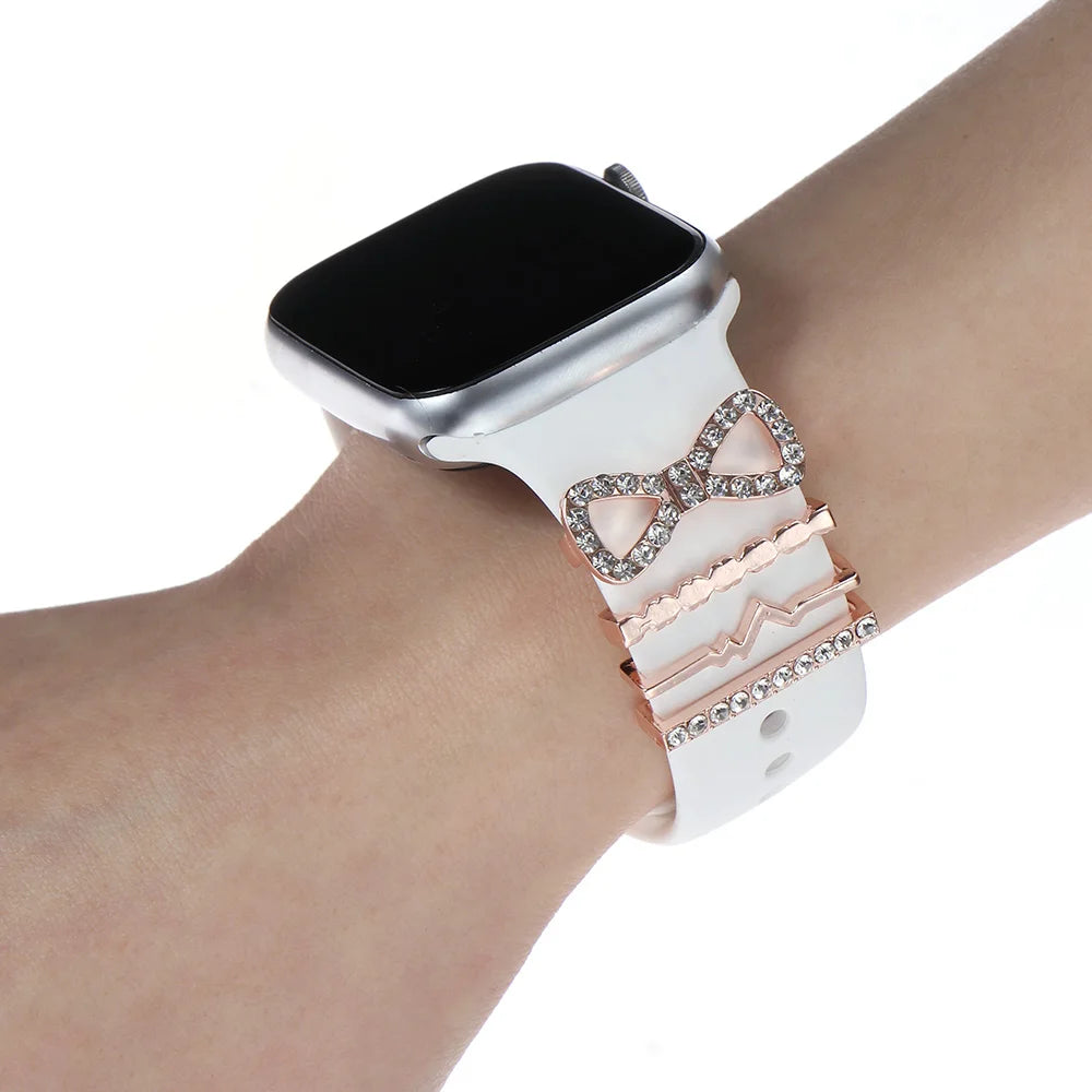 Decorative metal charms on white Apple Watch band enhancing style and elegance for everyday wear.