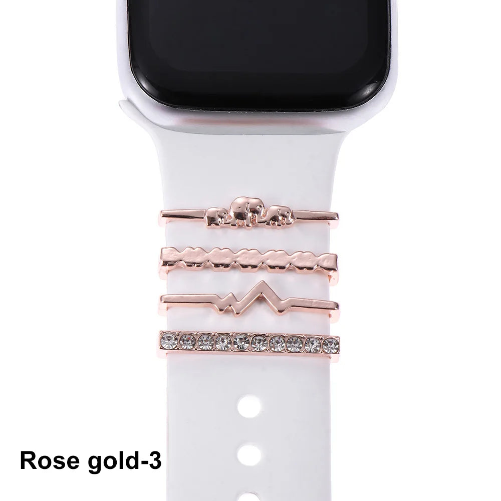 Decorative rose gold metal charms on white Apple Watch band for enhancing style and elegance.