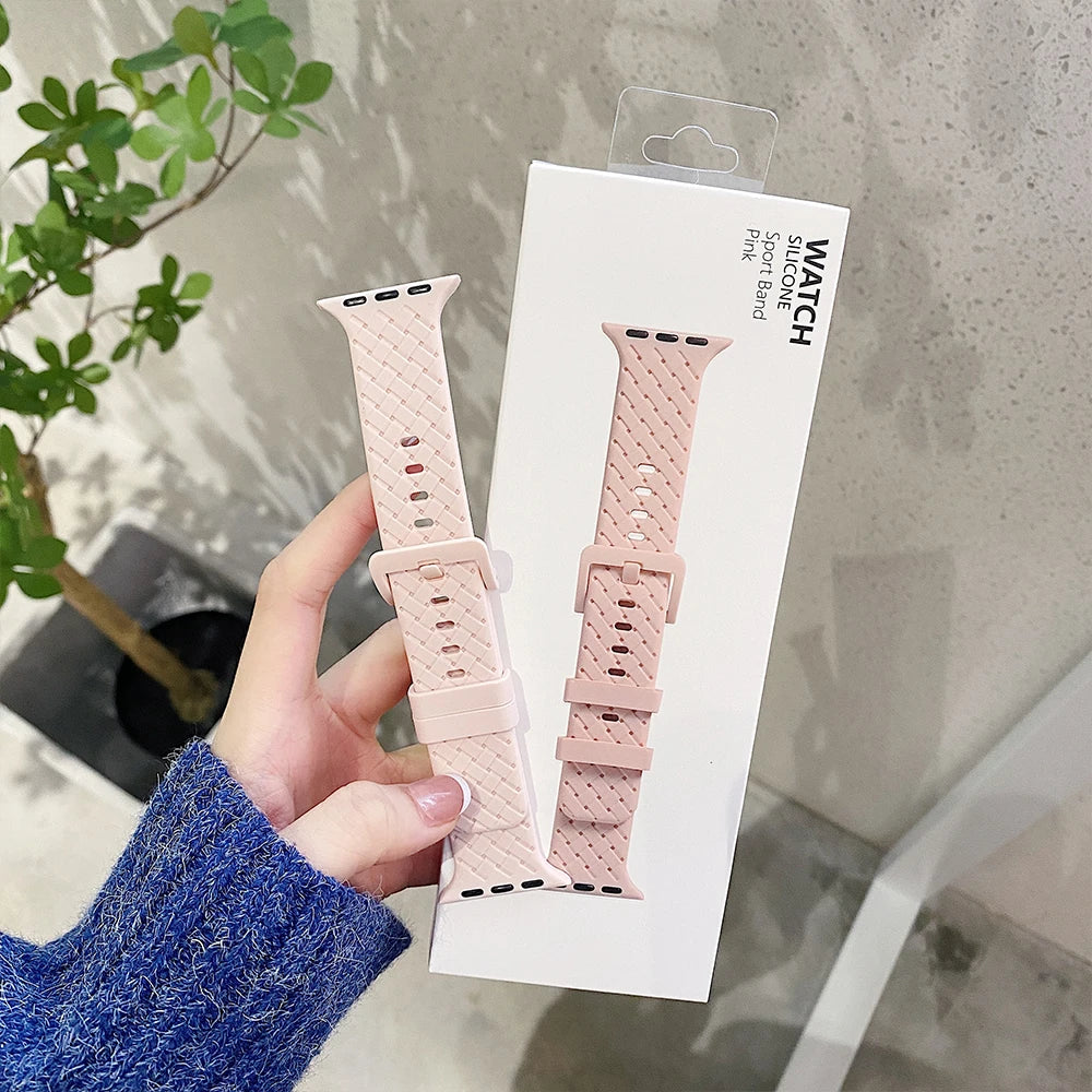 Soft pink basketweave-texture strap beside its display card for Apple Watch