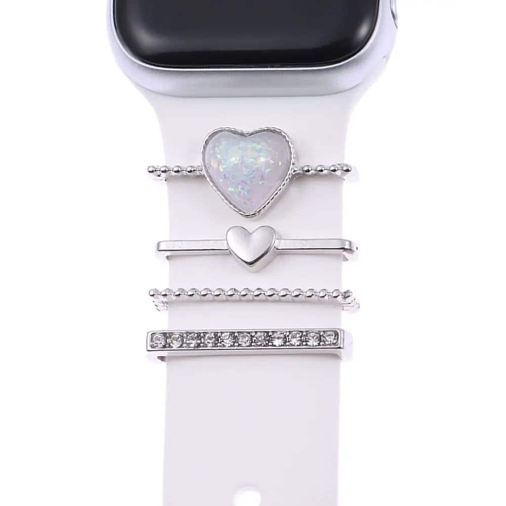 Decorative metal charms for Apple Watch bands featuring heart designs and elegant accents.