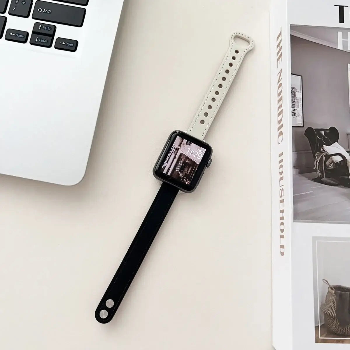 Black and ivory leather Apple Watch strap laid flat
