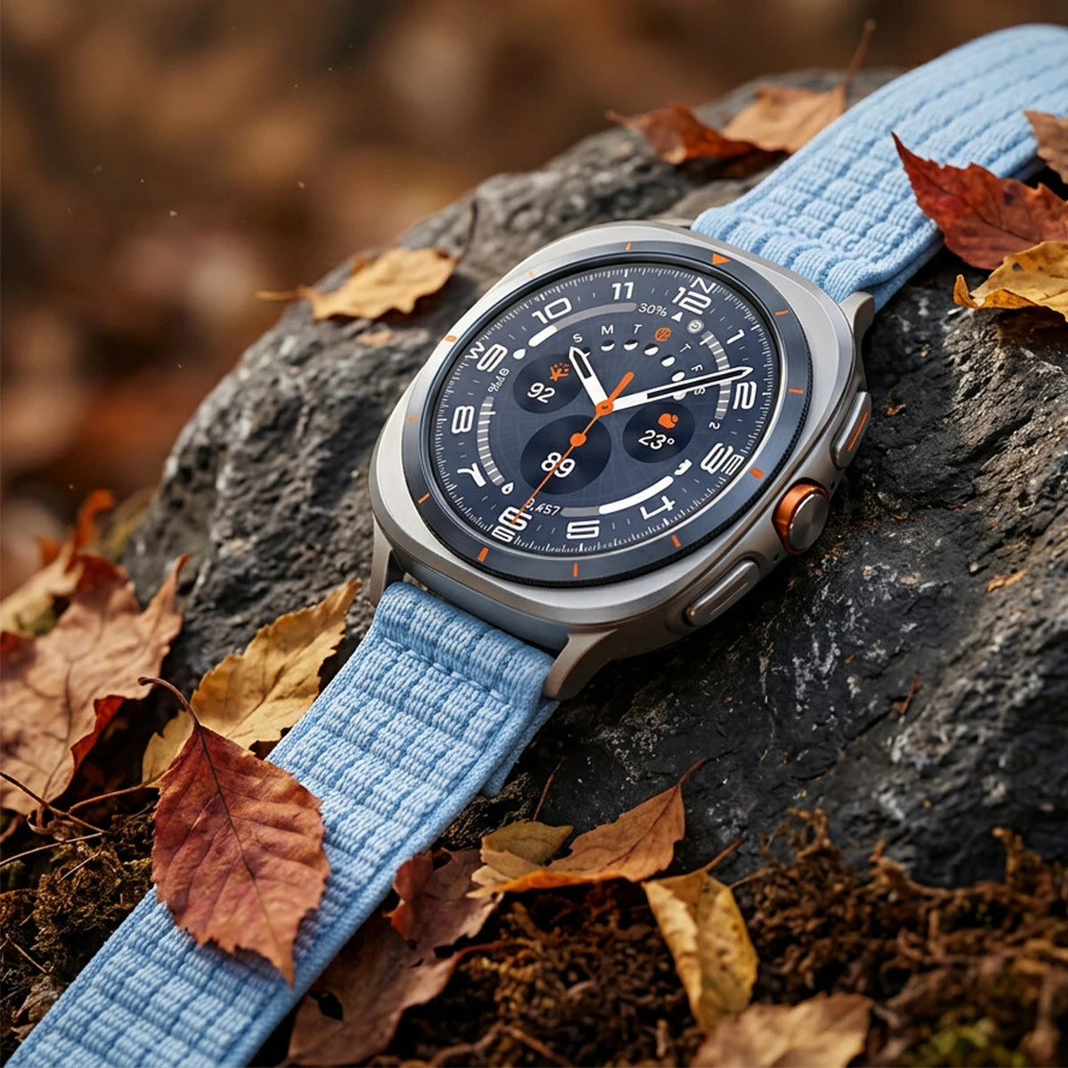 Samsung Galaxy Sport Nylon Woven Loop Watch Band – Watch8/Watch8 Classic/Watch9/Ultra/Ultra2 on a rocky surface with leaves.