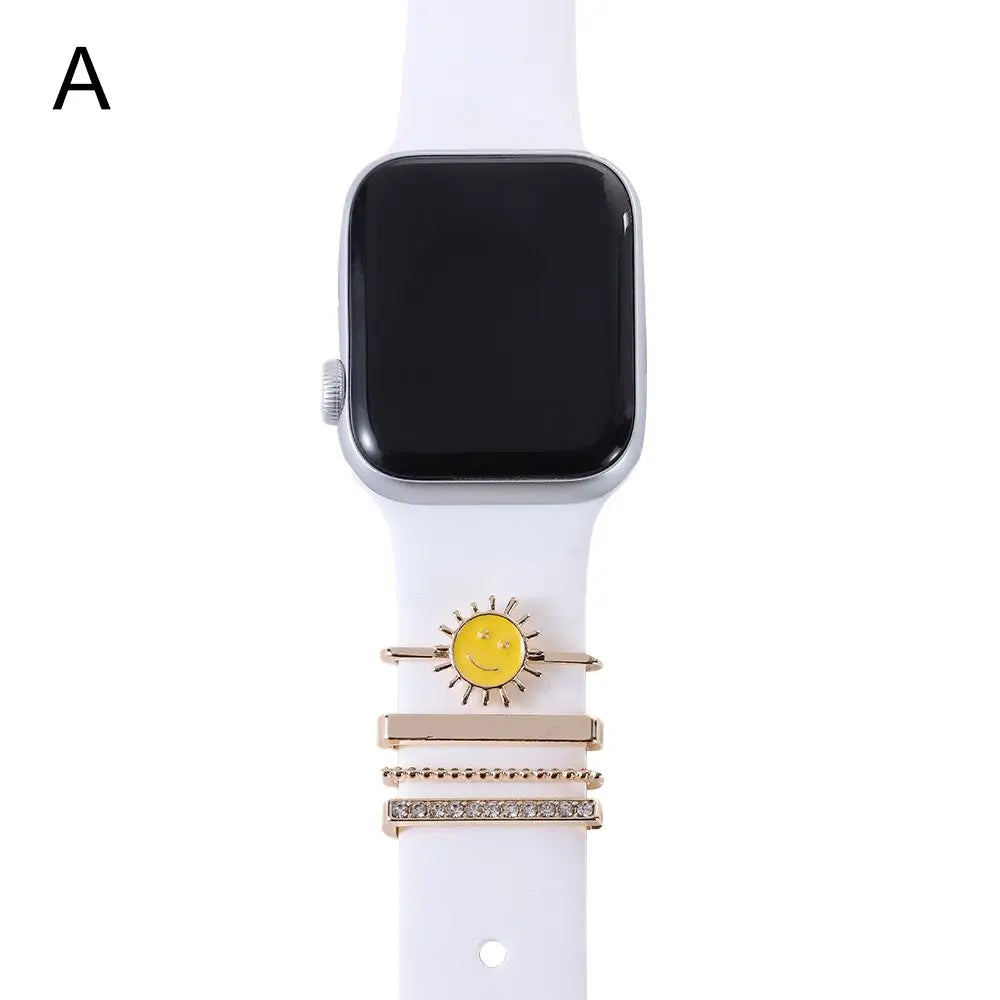 Decorative metal charms for Apple Watch bands, featuring a sunny smiley design and elegant gold accents.
