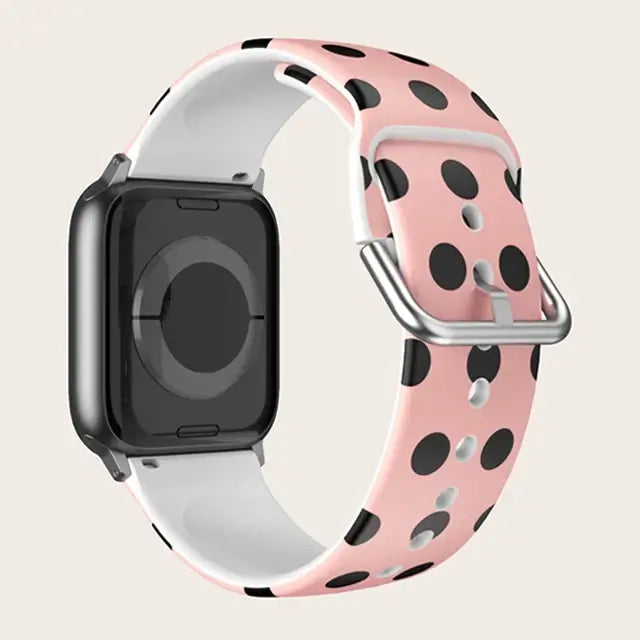Pink Polka Dot Apple Watch band with buckle and adjustment holes.