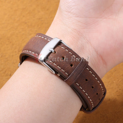 Garmin Vintage Stitched Leather Band in dark brown worn on a wrist