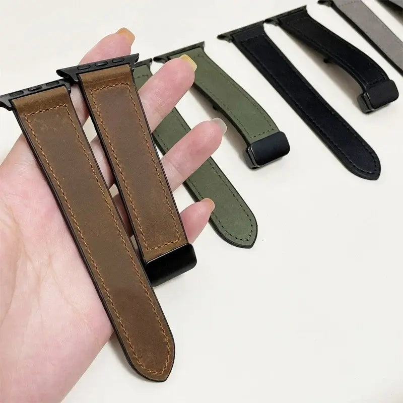 Brown leather Apple Watch straps held above other color options