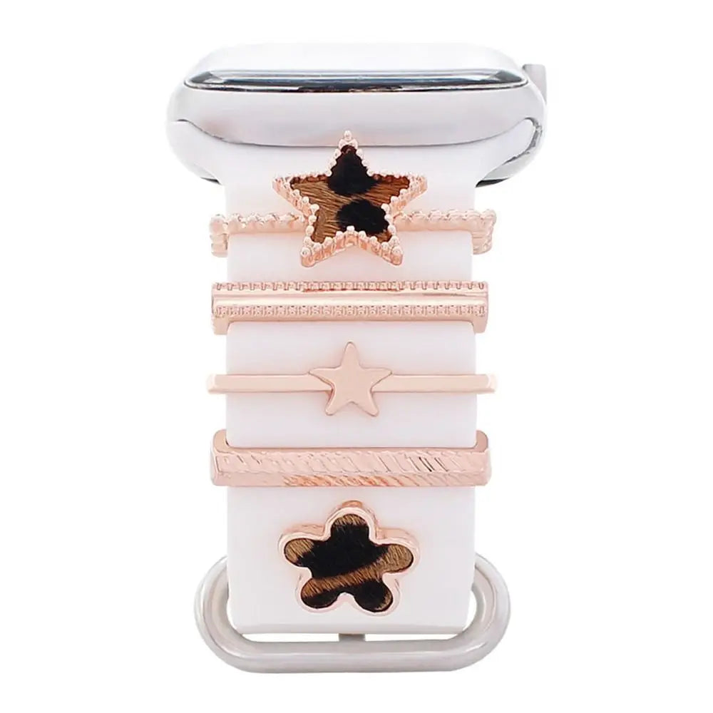 Decorative metal charms for Apple Watch bands, featuring stylish star and flower designs in elegant rose gold.