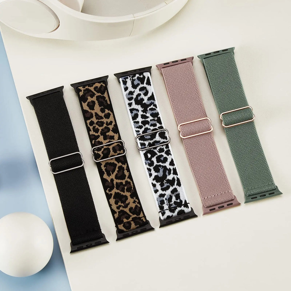 Five stretch nylon loops displayed in assorted colors and patterns for Apple Watch