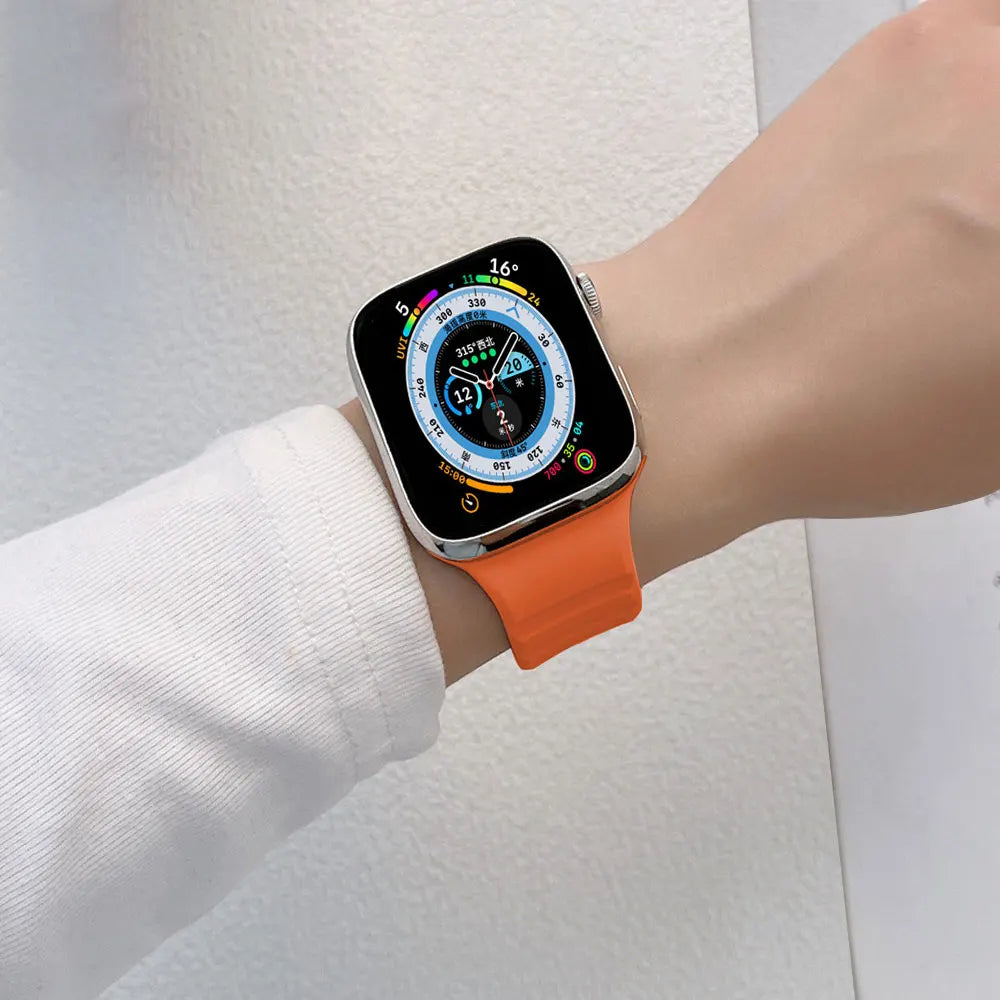 Orange slotted band worn on a wrist for Apple Watch