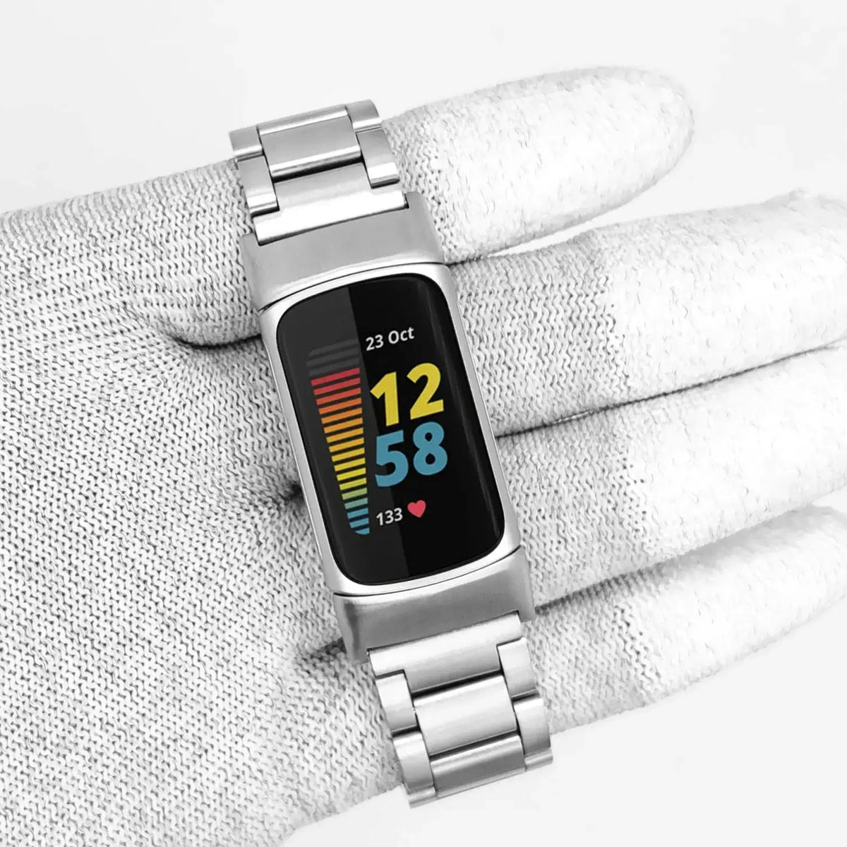 Fitbit Charge 5 & 6 Stainless Steel Three-Link Band silver bracelet held with a tracker