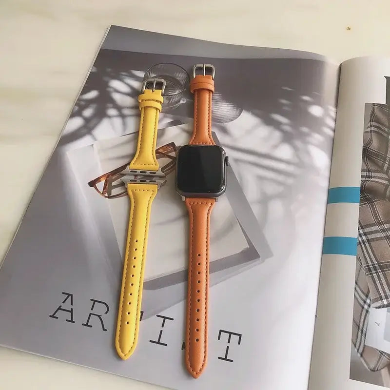 Yellow and orange tapered leather Apple Watch bands laid flat