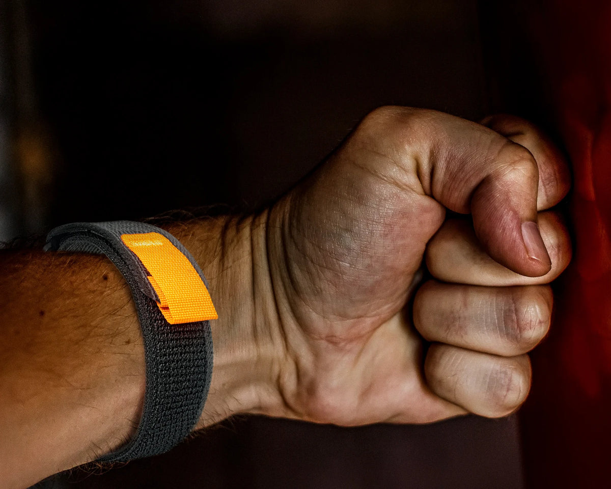 Garmin QuickFit Woven Nylon Trail Loop Band black loop with orange tab shown on a wrist