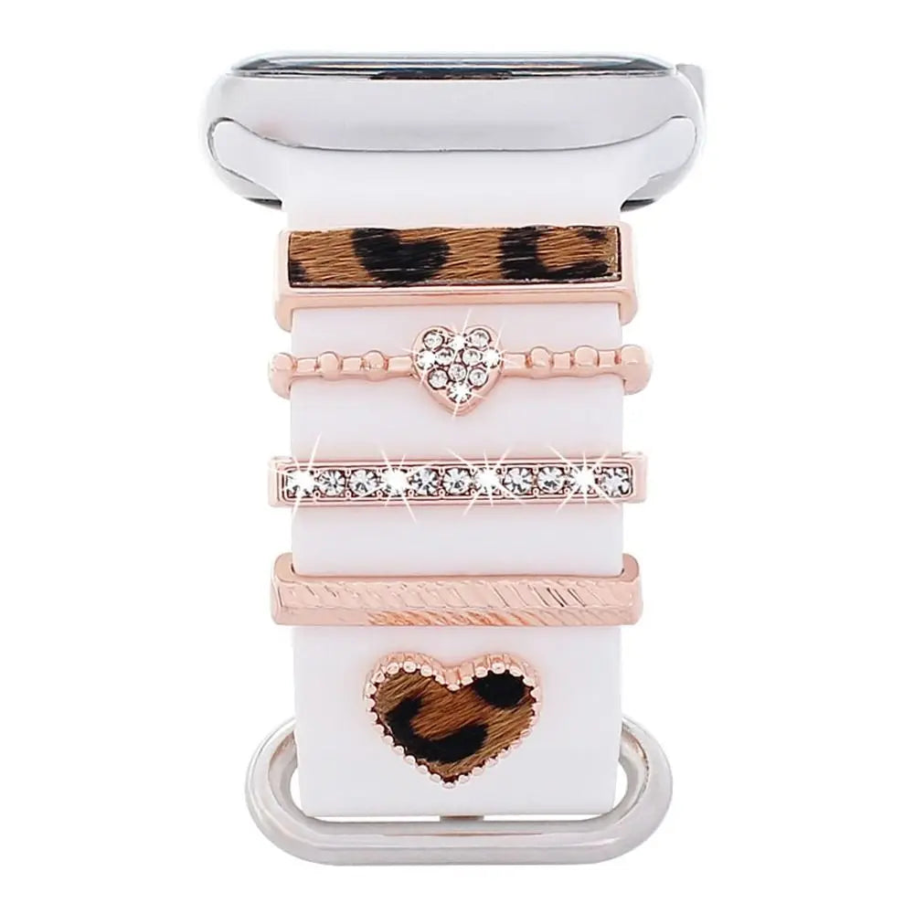 Decorative metal charms for Apple Watch bands in stylish designs featuring heart and animal print patterns.