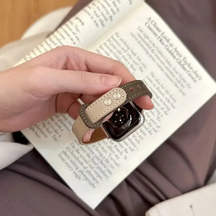 Close-up of stud fastening on two-tone leather Apple Watch band