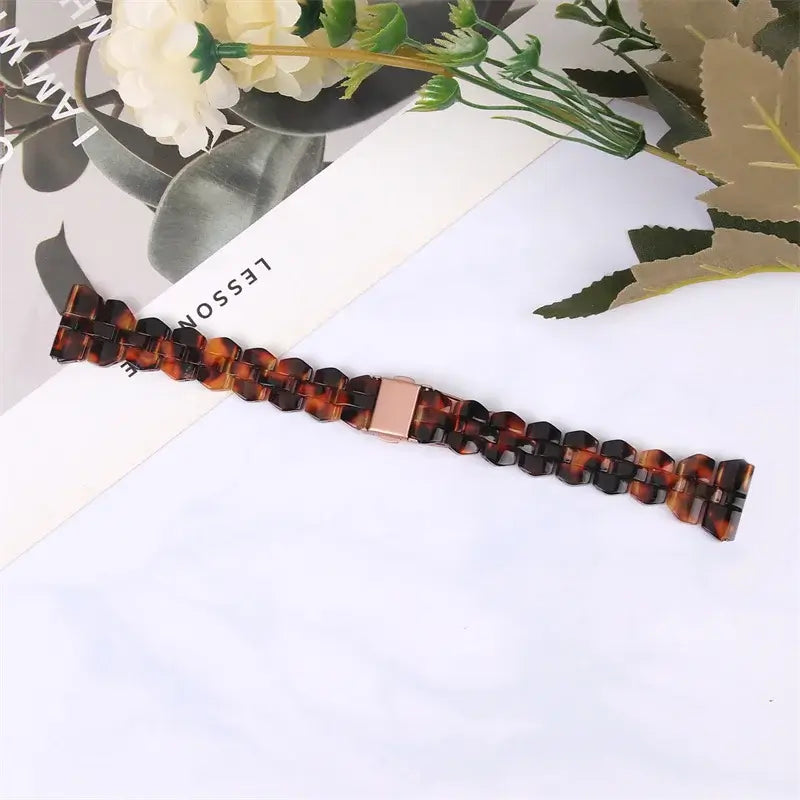 Tortoiseshell resin strap laid flat