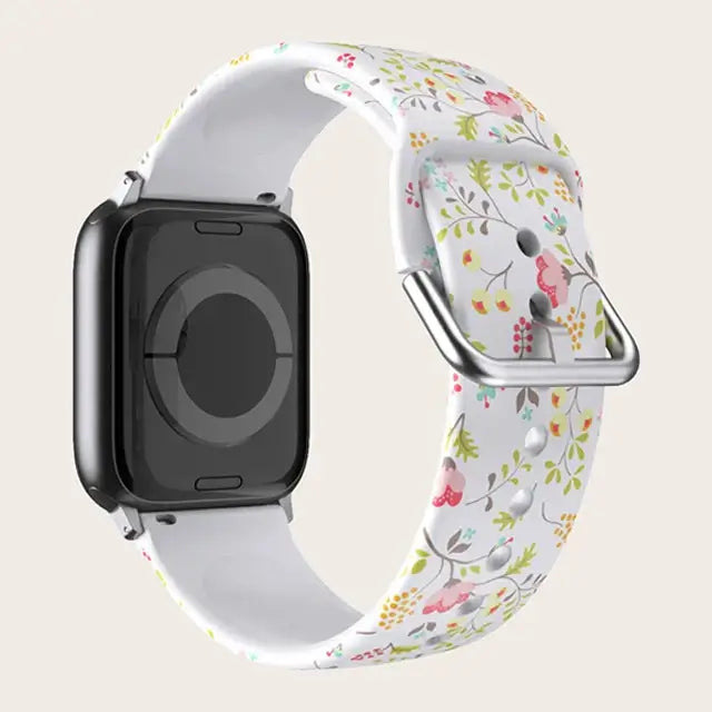 White Floral Apple Watch band with buckle and adjustment holes.
