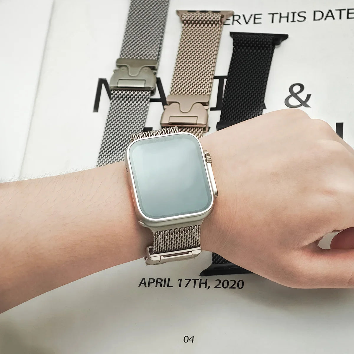 Mesh band worn on a wrist with other finishes in background for Apple Watch