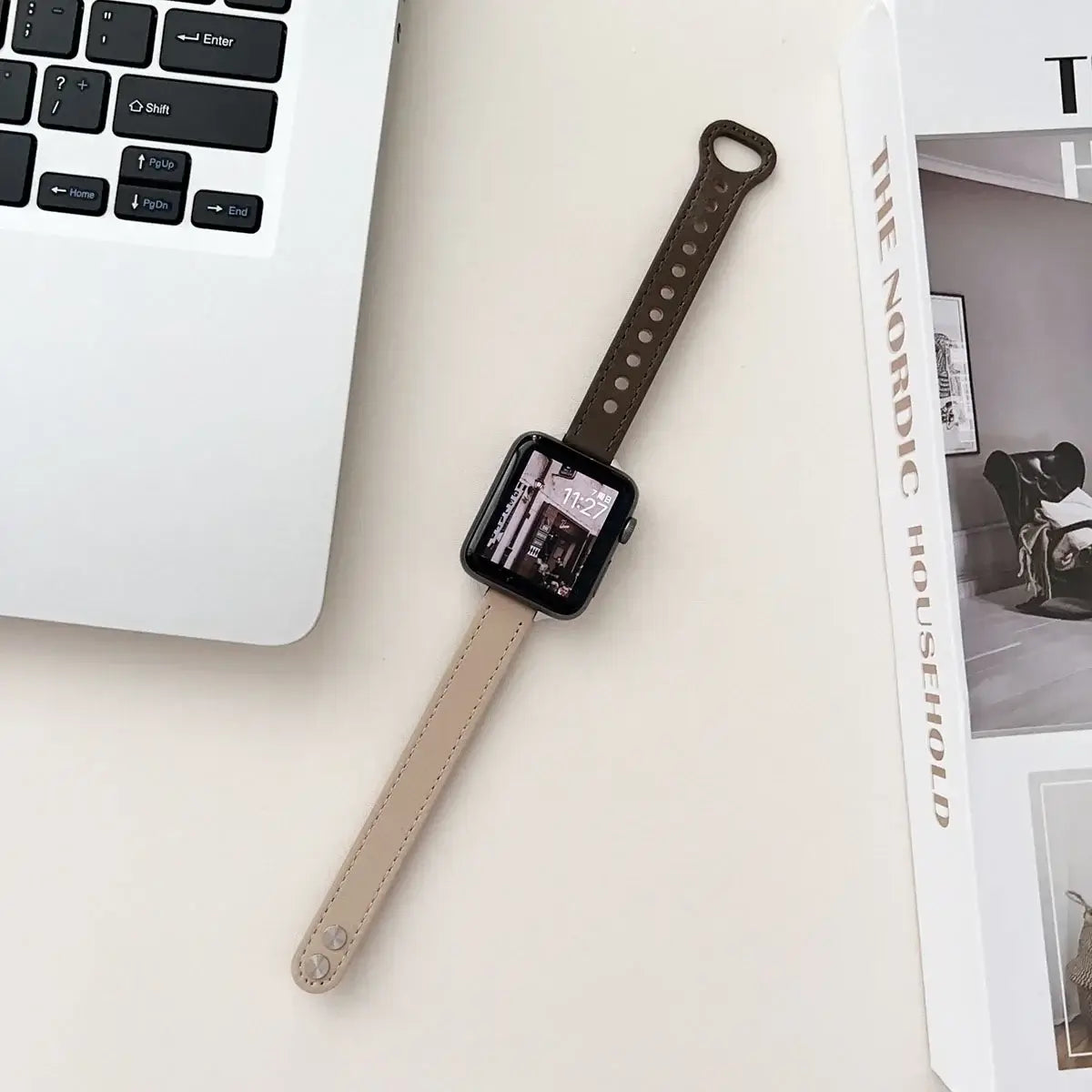 Taupe and dark brown two-tone Apple Watch strap laid flat
