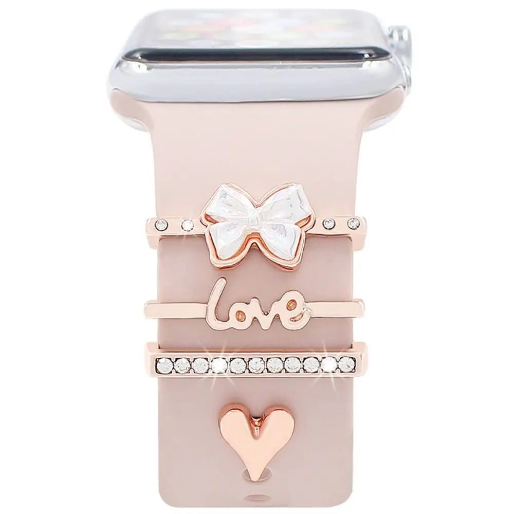 Decorative metal charms for Apple Watch bands, featuring a bow, heart, and 'love' design for added elegance.