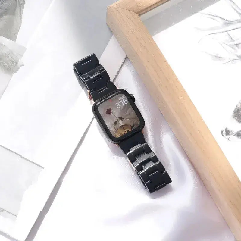 Black resin Apple Watch bracelet on a desk