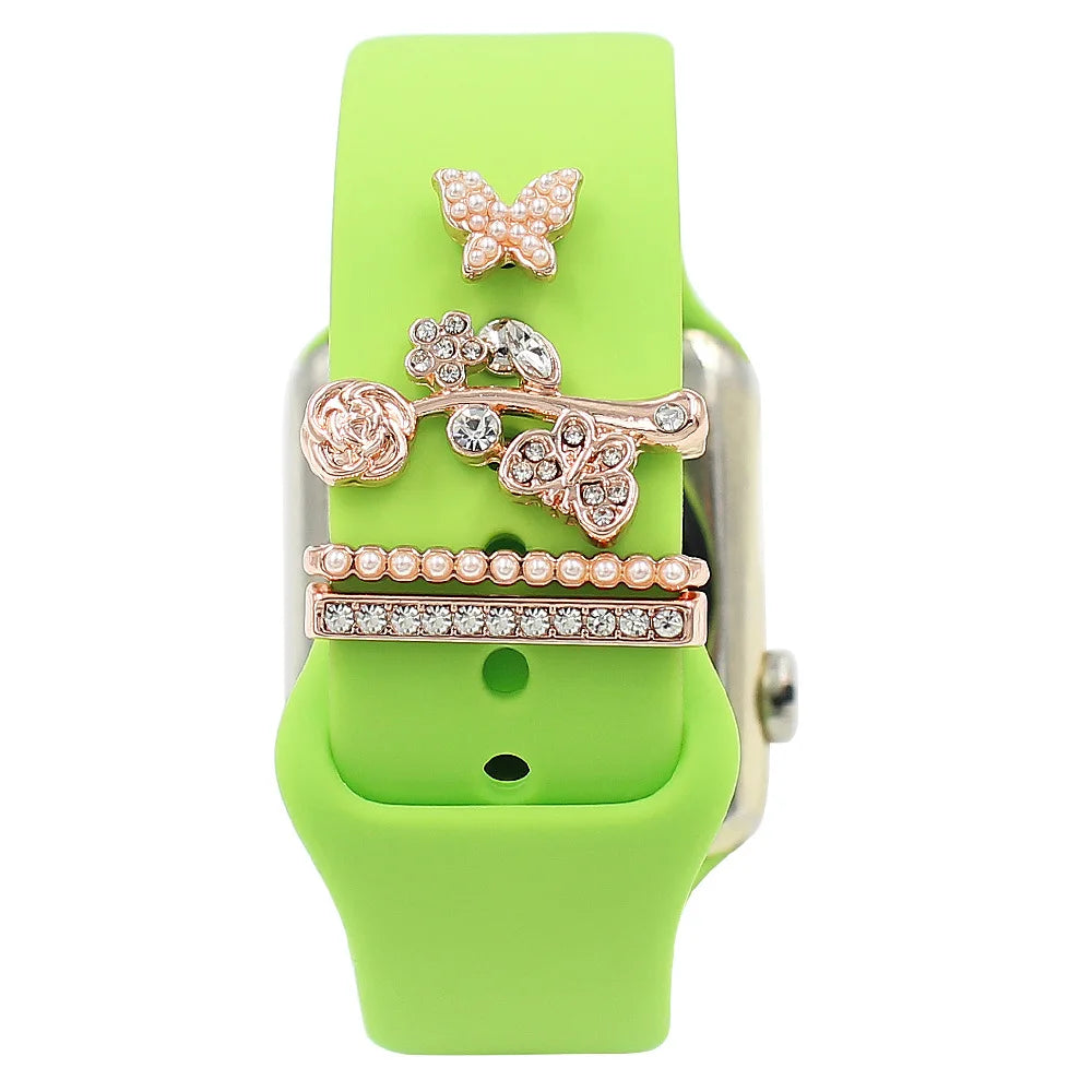 Decorative metal charms on a green Apple Watch band, adding elegance and style to smartwatch accessories.