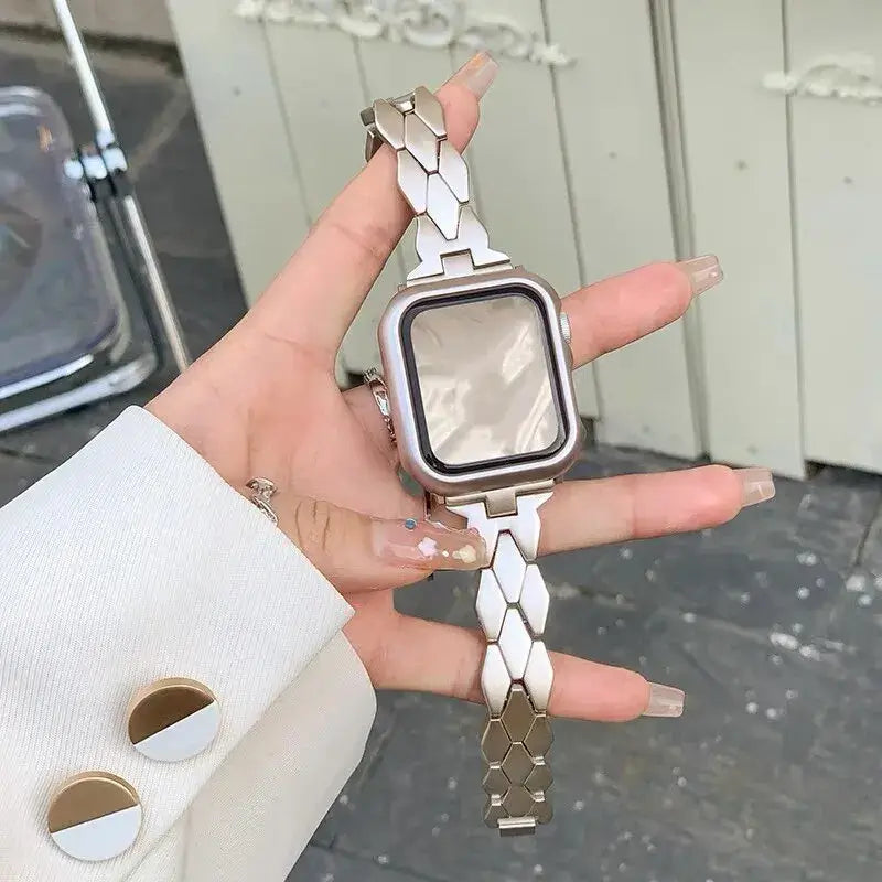 Starlight herringbone Apple Watch band with angled metal links.