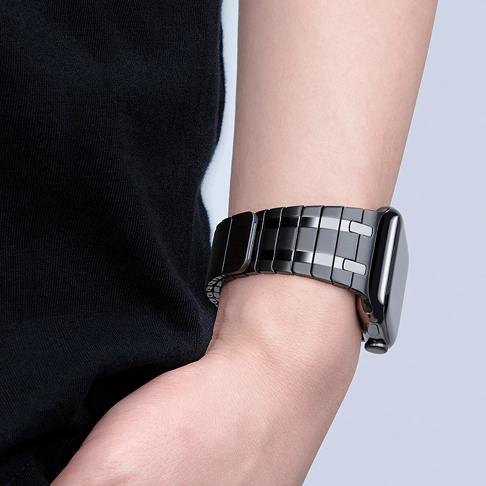 Black H-link band worn on a wrist for Apple Watch