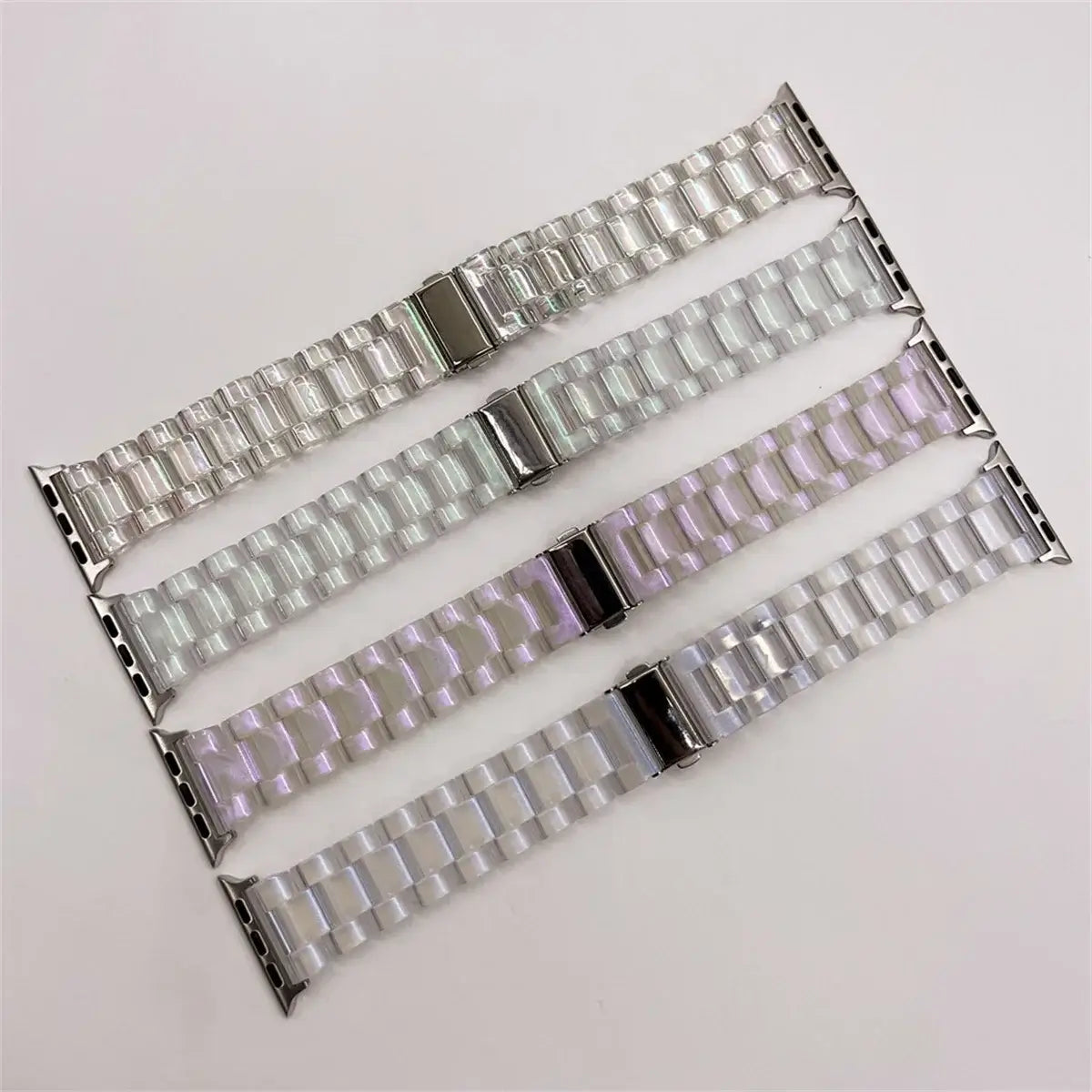 Four iridescent resin Apple Watch band colors displayed together