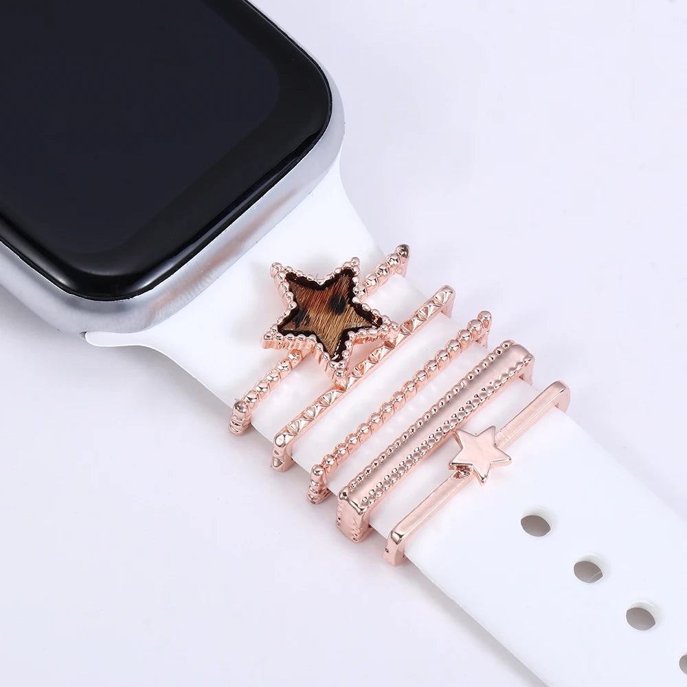Decorative metal charms on an Apple Watch band, adding elegance and personality to a smartwatch.