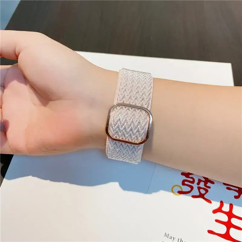 Light gray textured Apple Watch band worn on wrist