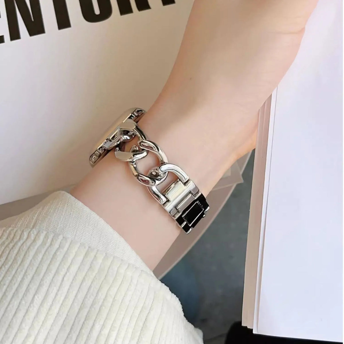 Silver chain bracelet band worn on a wrist