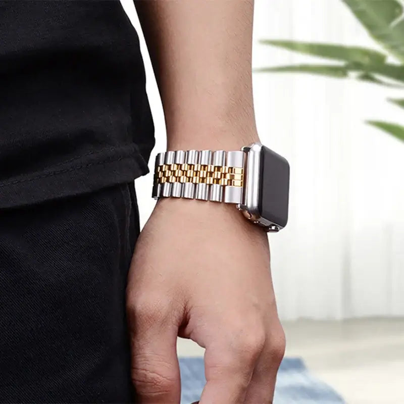 Silver and Gold five-row Apple Watch bracelet worn on wrist