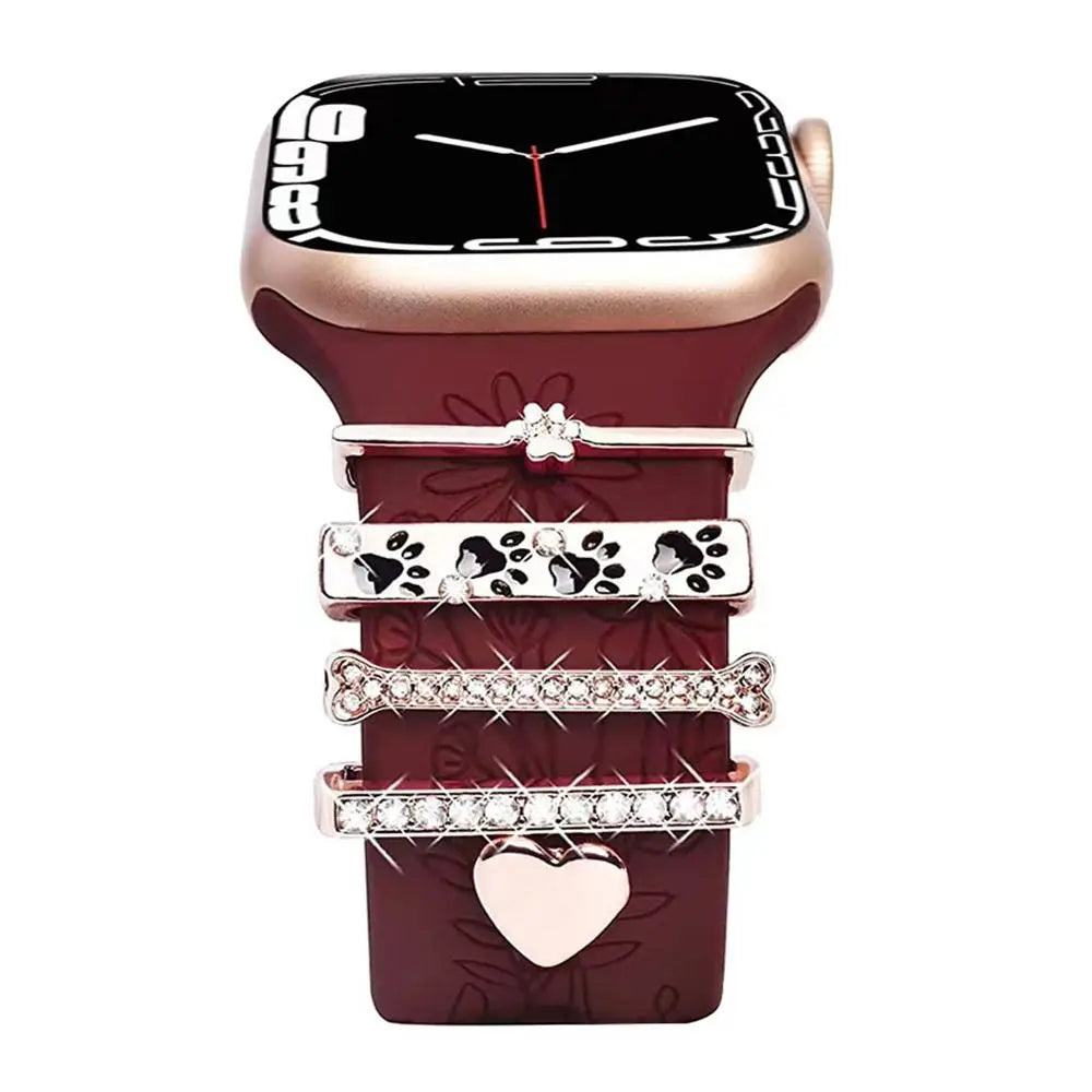 Decorative metal charms on a stylish burgundy Apple Watch band, enhancing elegance and personalized fashion.