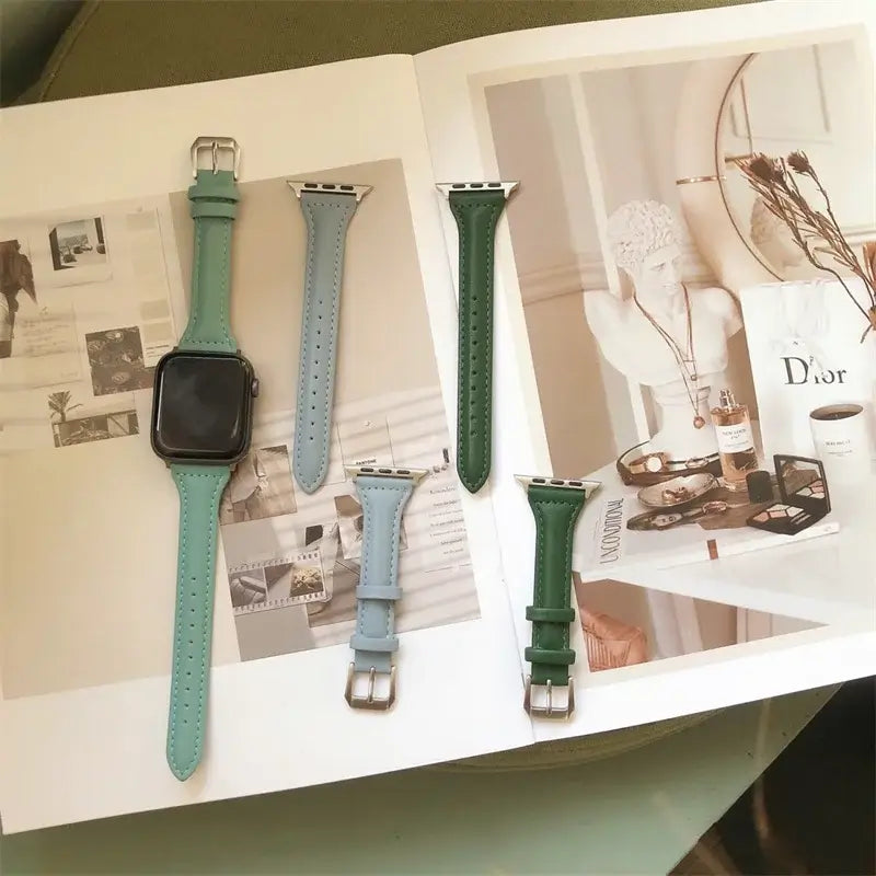 Green and blue tapered leather Apple Watch straps on display