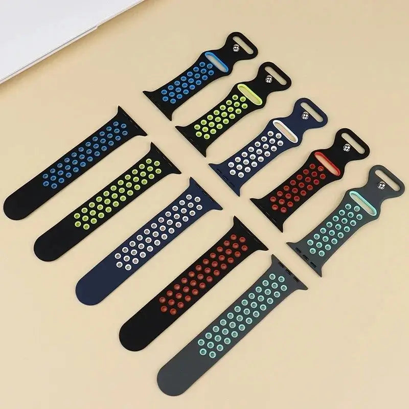 Perforated silicone Apple Watch straps laid flat in contrasting colors